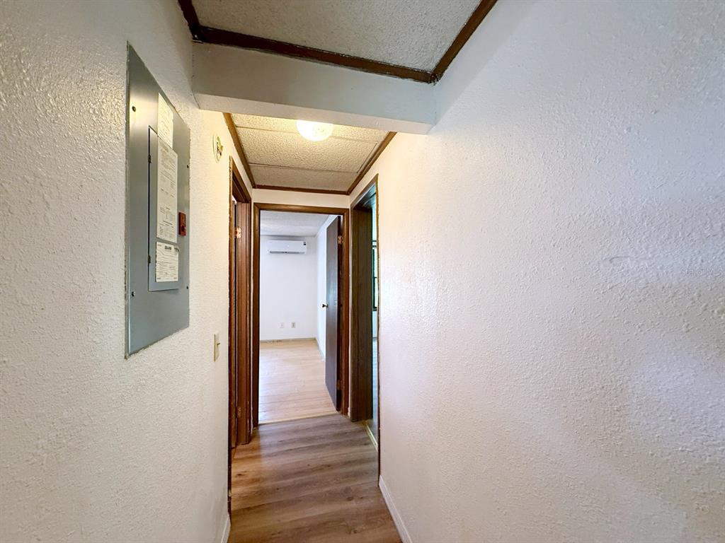 33248 Ridge Manor Boulevard Dade City, FL 33523 - Photo 16 of 20 a view of a hallway with wooden floor