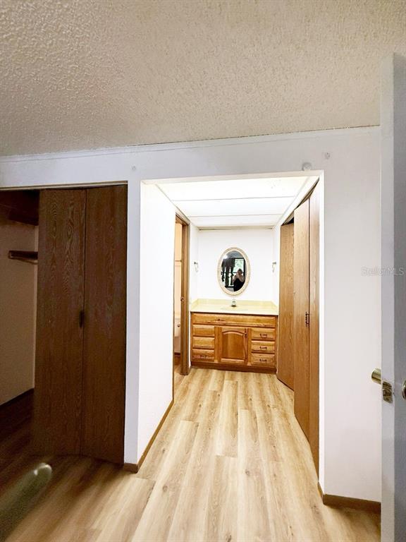 33248 Ridge Manor Boulevard Dade City, FL 33523 - Photo 10 of 20 a view of a hallway with wooden floor