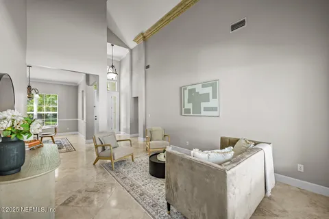 a dining room with chairs and chandelier