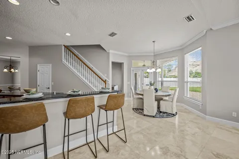 a living room with furniture a fireplace and a large window