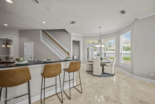 a living room with furniture a fireplace and a large window