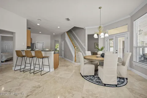 a spacious bedroom with a bed and a flat screen tv