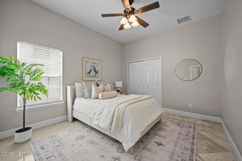 a bathroom with a granite countertop toilet sink and mirror