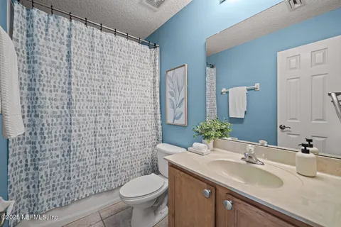 an aerial view of residential houses with outdoor space and street view