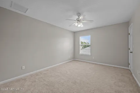 an aerial view of a house with a garden and a yard