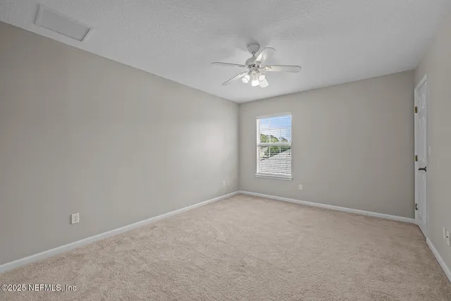 an aerial view of a house with a garden and a yard