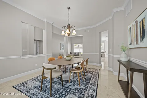 a living room with furniture a window and a mirror