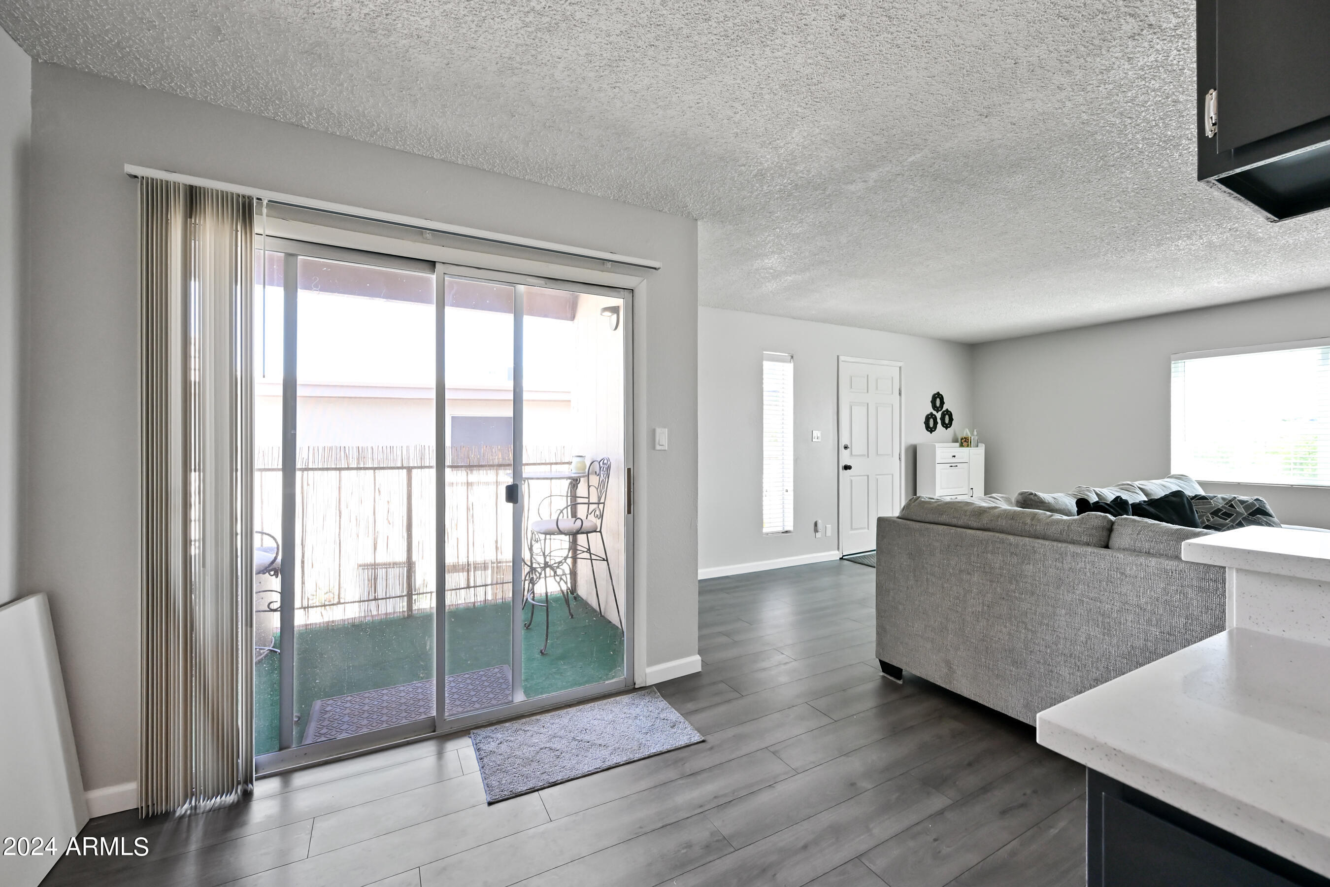 17009 East Calle Del Oro, Unit D Fountain Hills, AZ 85268 - Photo 11 of 18 a living room with furniture a flat screen tv and a floor to ceiling window