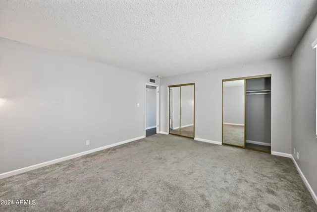an empty room with closet area