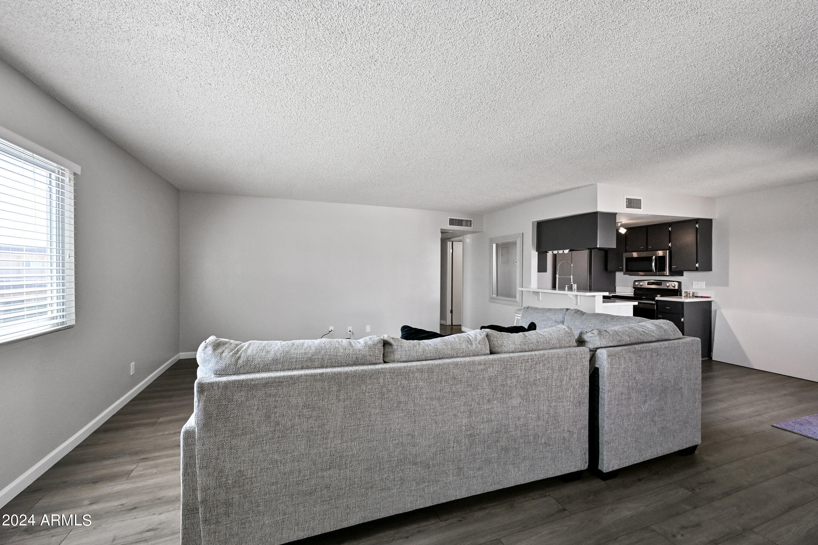 17009 East Calle Del Oro, Unit D Fountain Hills, AZ 85268 - Photo 3 of 18 a living room with furniture and a flat screen tv