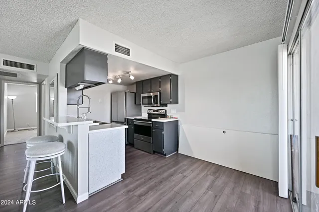 a kitchen with kitchen island white cabinets and stainless steel appliances