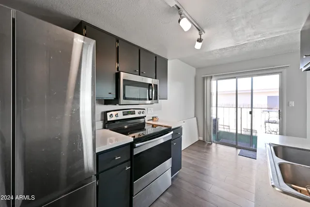 a kitchen with a refrigerator stove and microwave