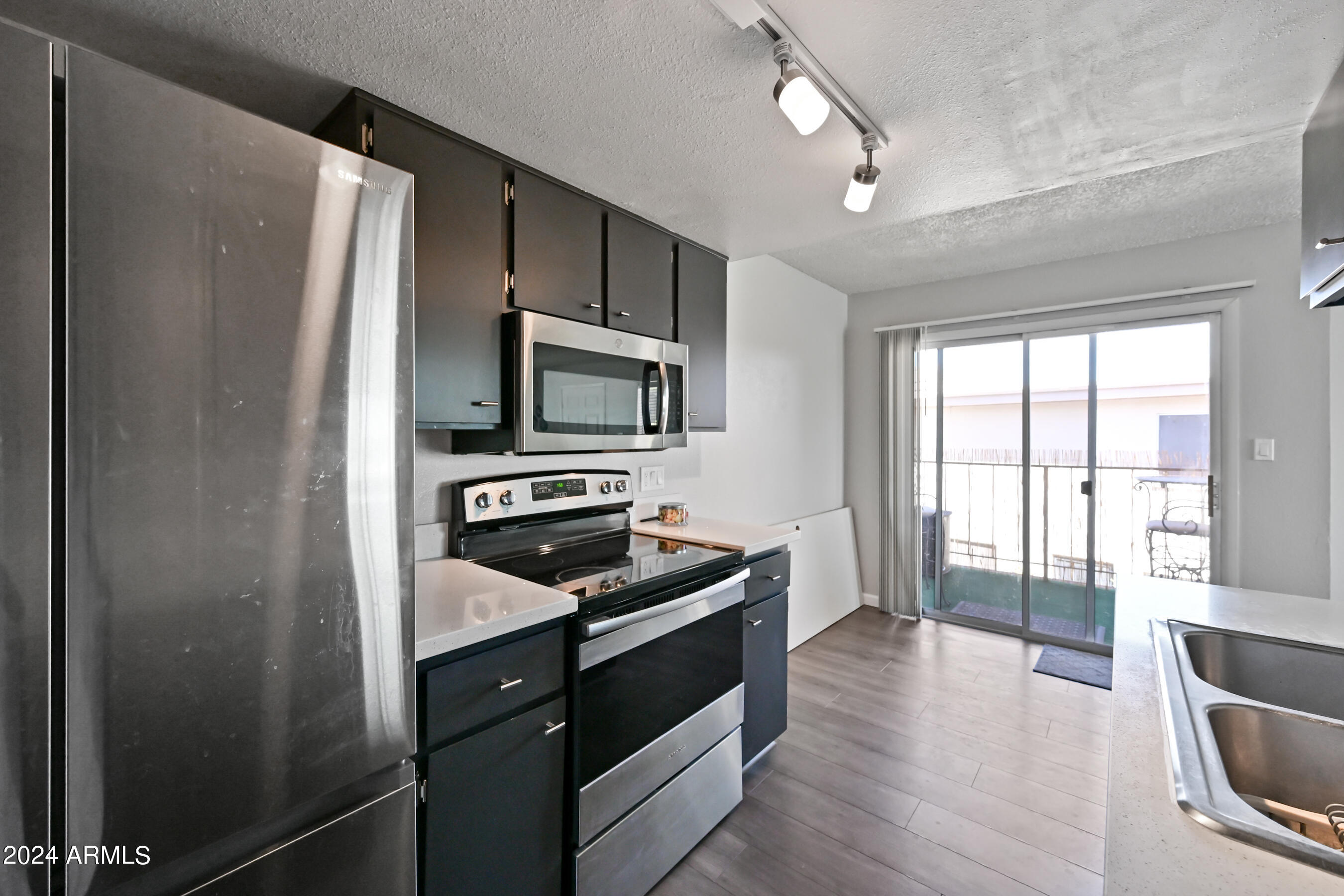 17009 East Calle Del Oro, Unit D Fountain Hills, AZ 85268 - Photo 10 of 18 a kitchen with a refrigerator stove and microwave