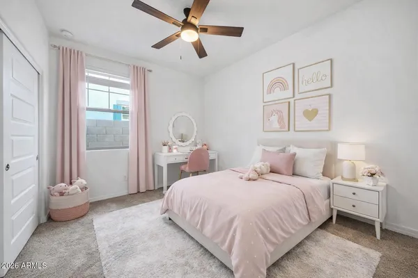an empty room with a window and a fan