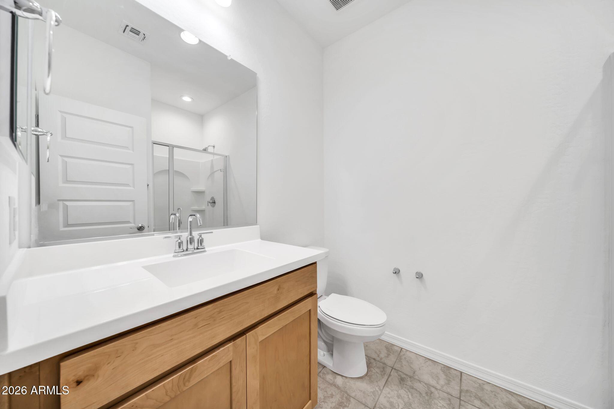 10223 West Piccadilly Road Avondale, AZ 85392 - Photo 16 of 35 a bathroom with a sink a toilet and vanity