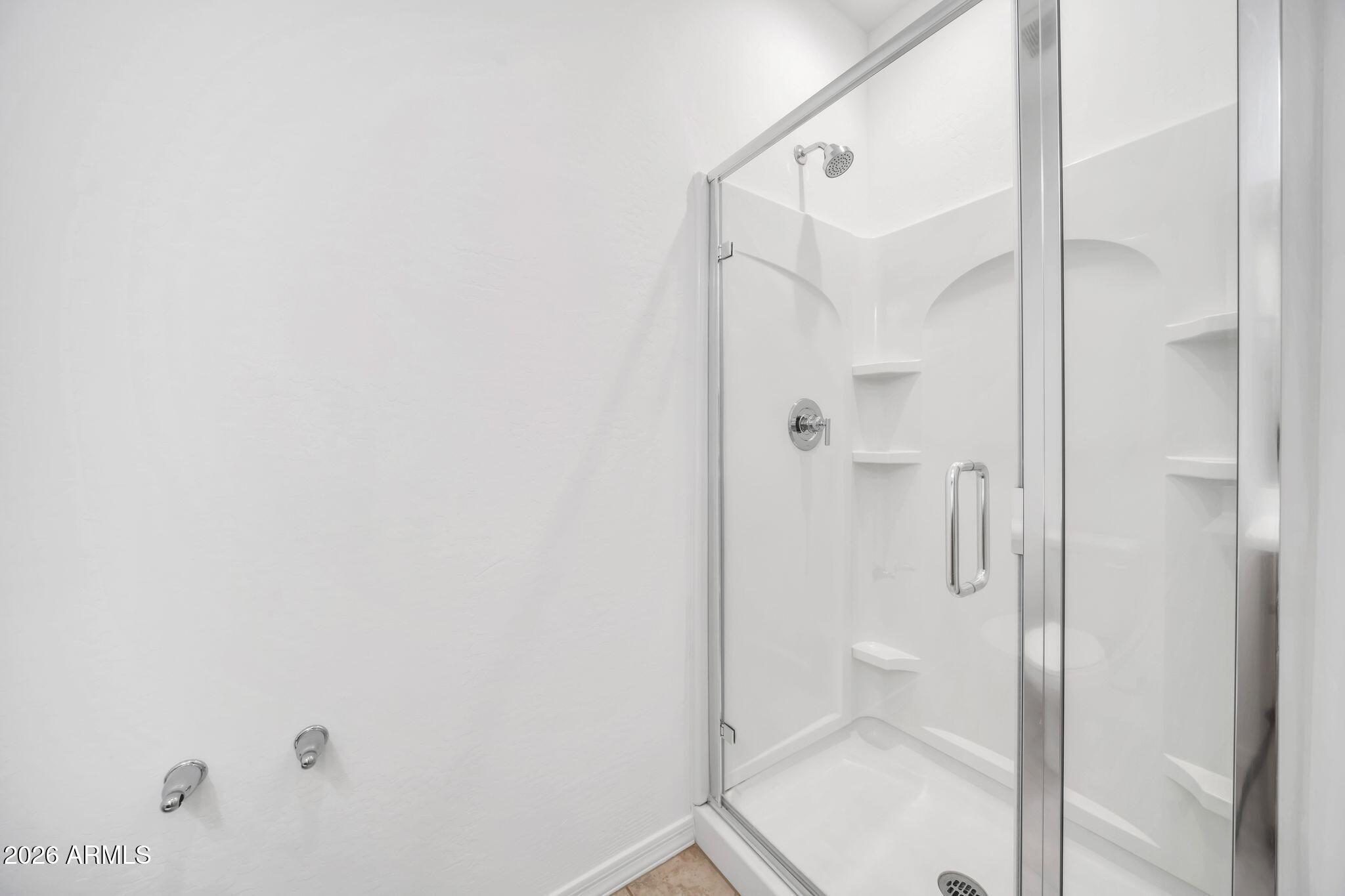 10223 West Piccadilly Road Avondale, AZ 85392 - Photo 17 of 35 a bathroom with a shower and toilet