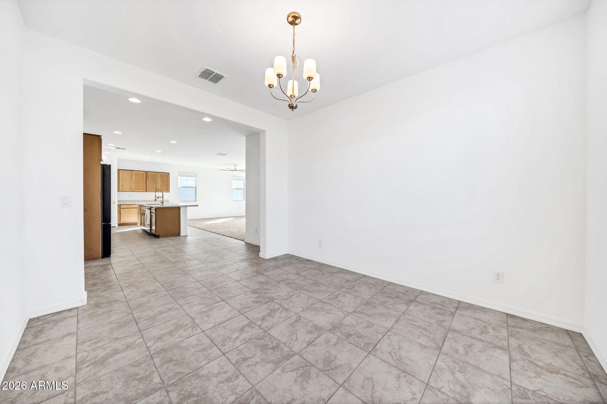 10223 West Piccadilly Road Avondale, AZ 85392 - Photo 21 of 35 a view of a kitchen with a sink and a chandelier