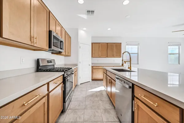 a kitchen with granite countertop a refrigerator and a sink