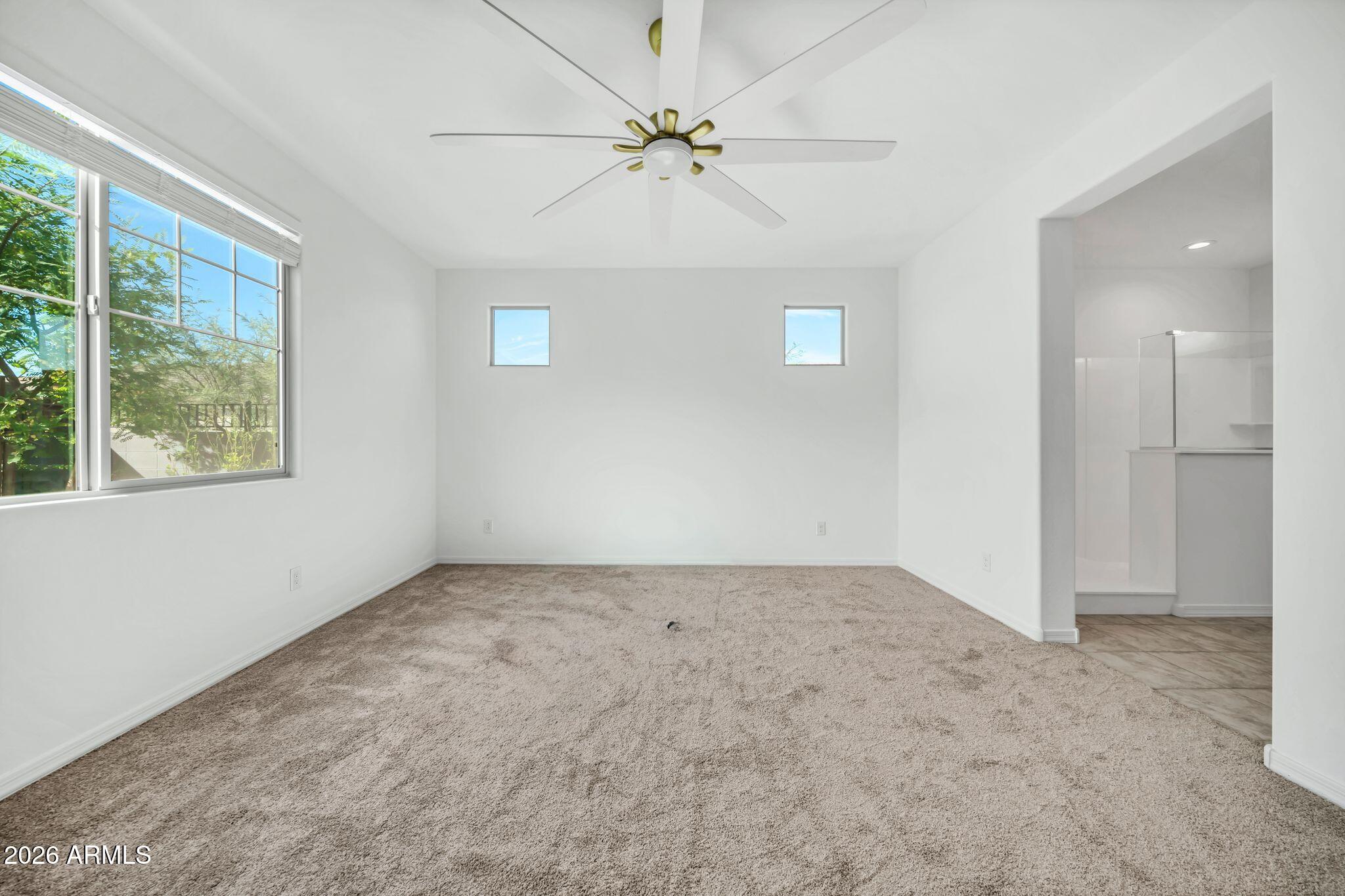 10223 West Piccadilly Road Avondale, AZ 85392 - Photo 8 of 35 an empty room with fan and windows