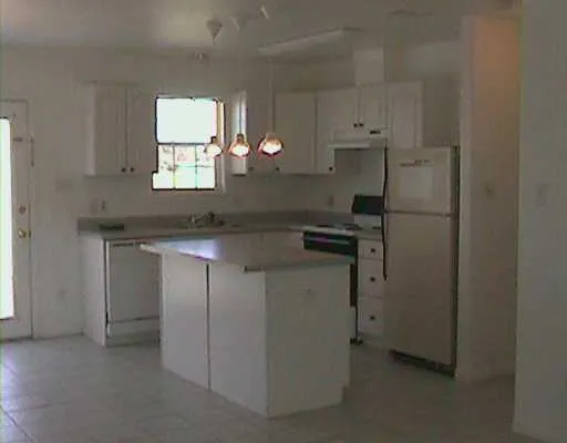 a kitchen with stainless steel appliances a refrigerator sink and cabinets