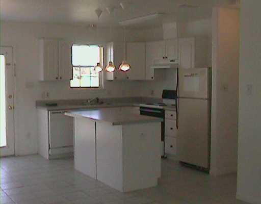218 Oak Ridge Drive Corpus Christi, TX 78418 - Photo 2 of 8 a kitchen with stainless steel appliances a refrigerator sink and cabinets