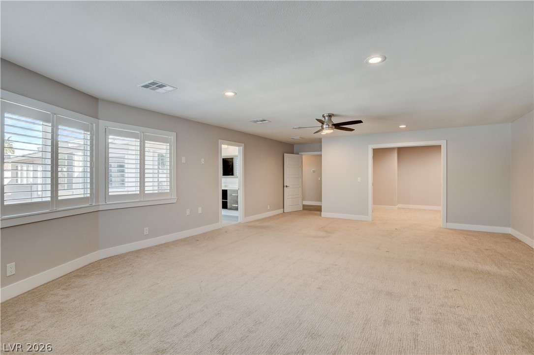 4207 Ridgecrest Drive Las Vegas, NV 89121 - Photo 14 of 27 Extra large primary bedroom with lots and lots of windows and space. Showing large walk-in closet ready to go!
