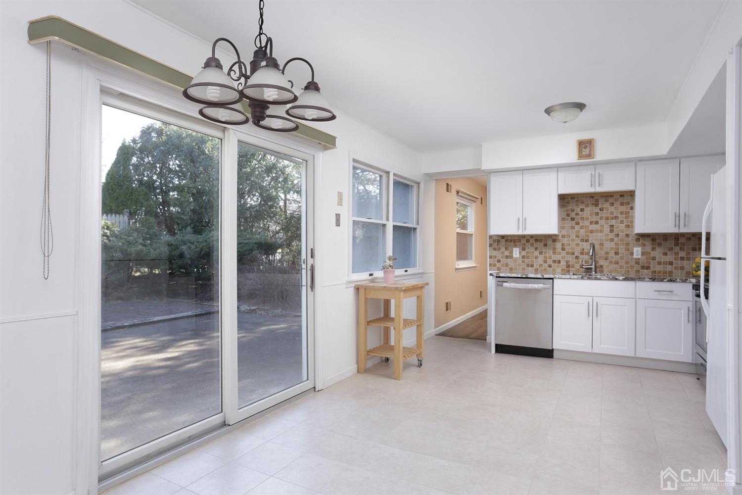 40 Azalea Drive Edison, NJ 08820 - Photo 13 of 36 a kitchen with stainless steel appliances granite countertop a refrigerator a sink dishwasher a stove and a dining table with wooden floor