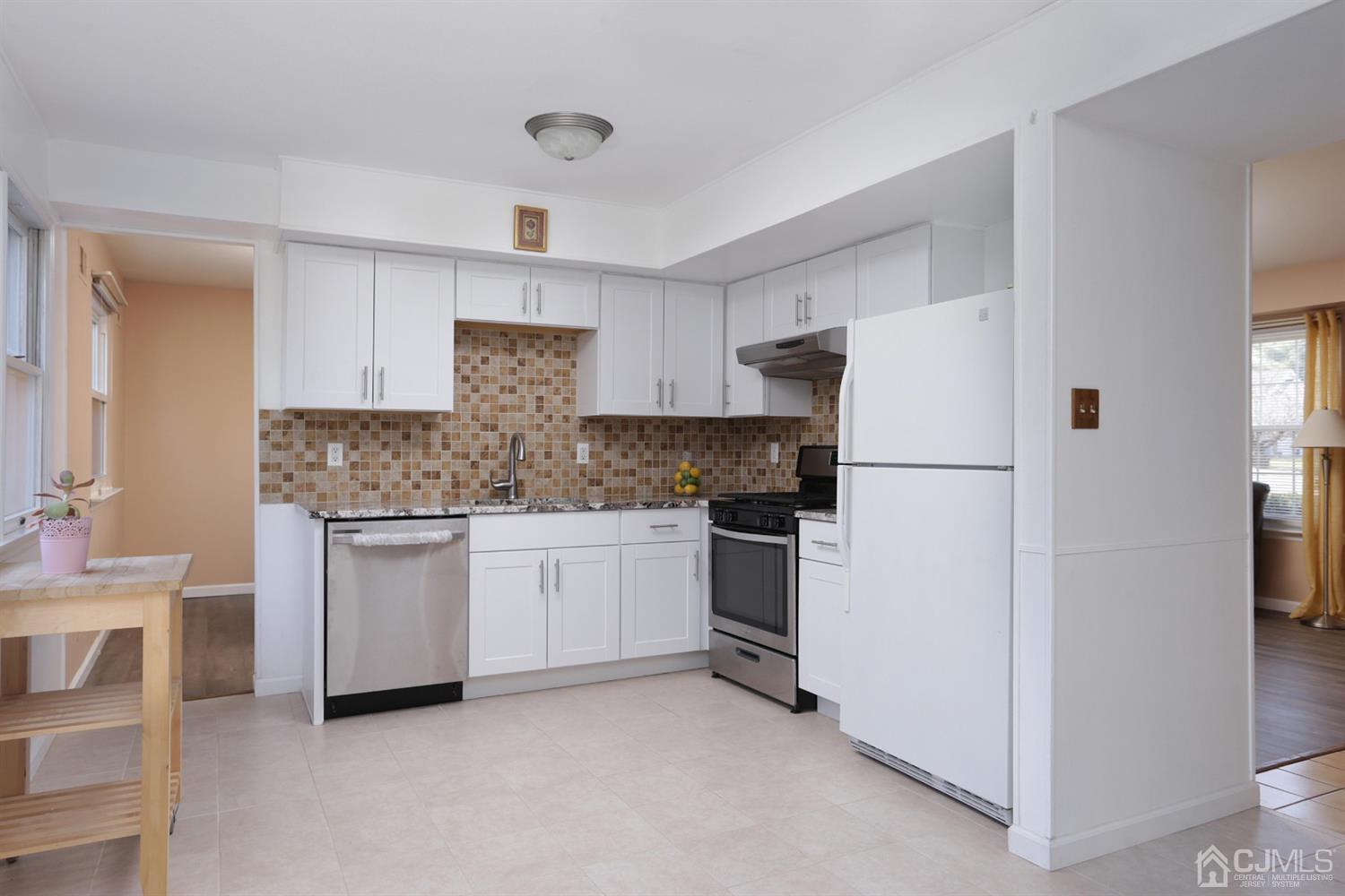 40 Azalea Drive Edison, NJ 08820 - Photo 15 of 36 a kitchen with white cabinets and white appliances