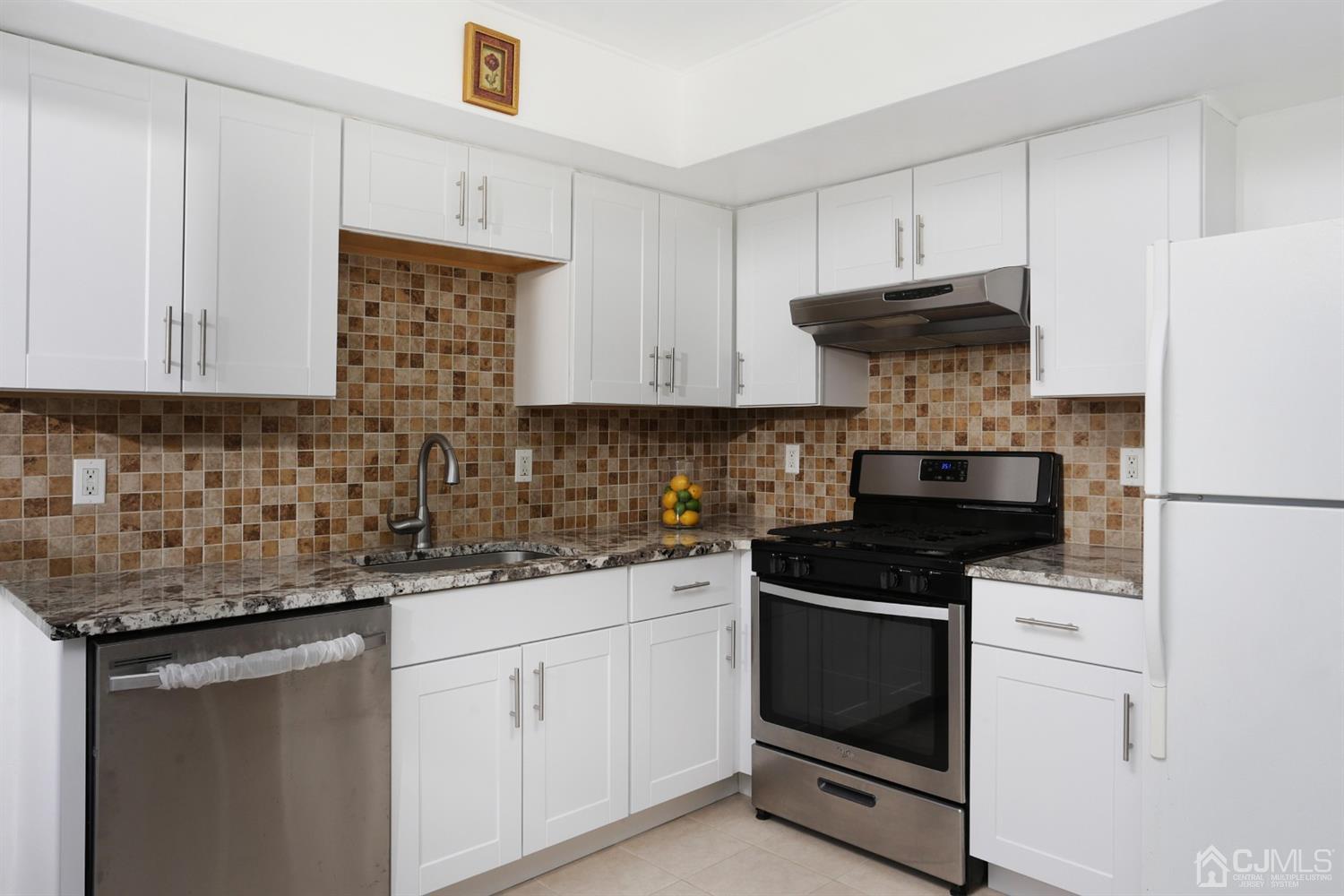 40 Azalea Drive Edison, NJ 08820 - Photo 17 of 36 a kitchen with stainless steel appliances granite countertop a sink and a stove