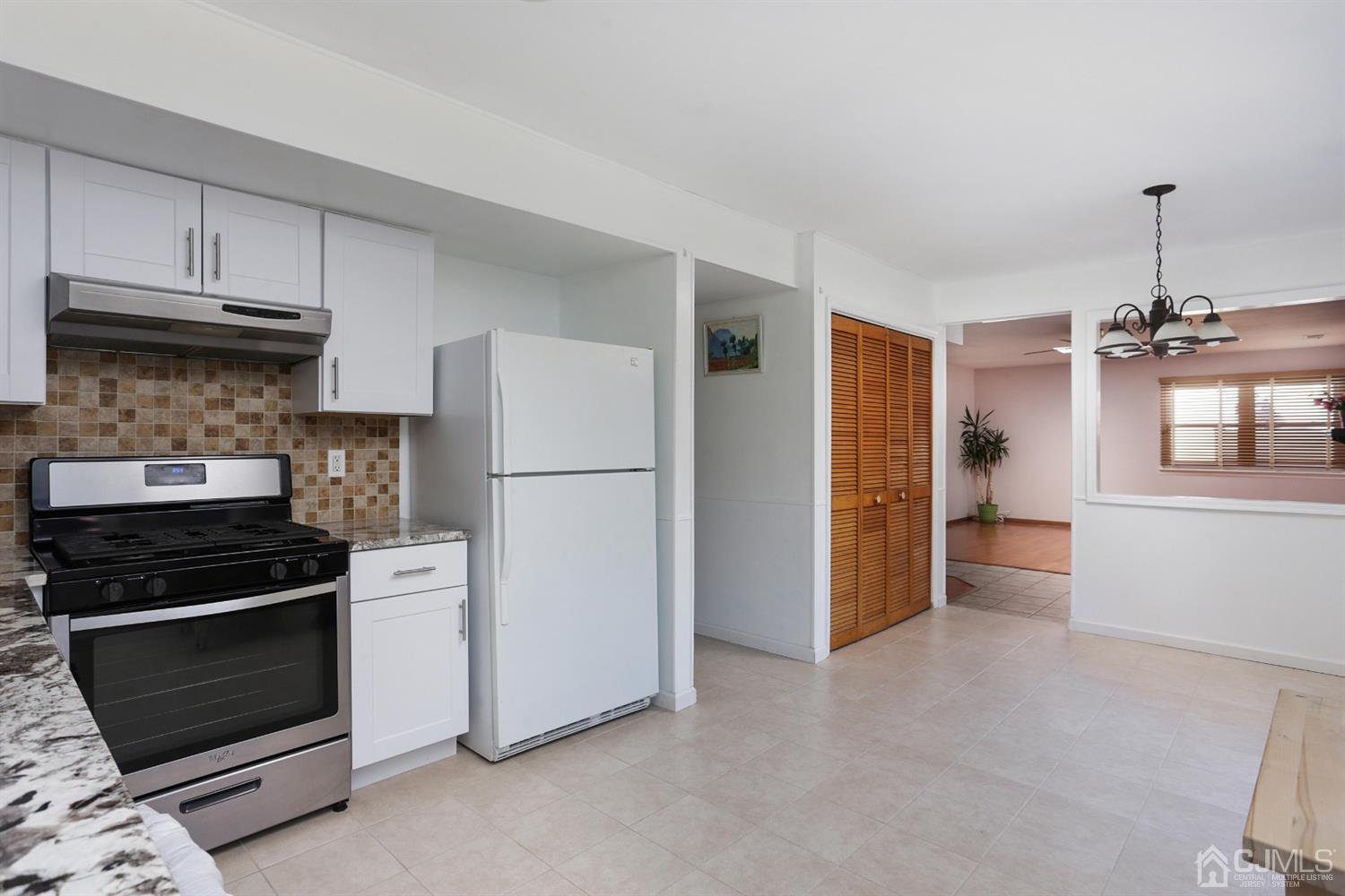 40 Azalea Drive Edison, NJ 08820 - Photo 18 of 36 a kitchen with refrigerator and cabinets