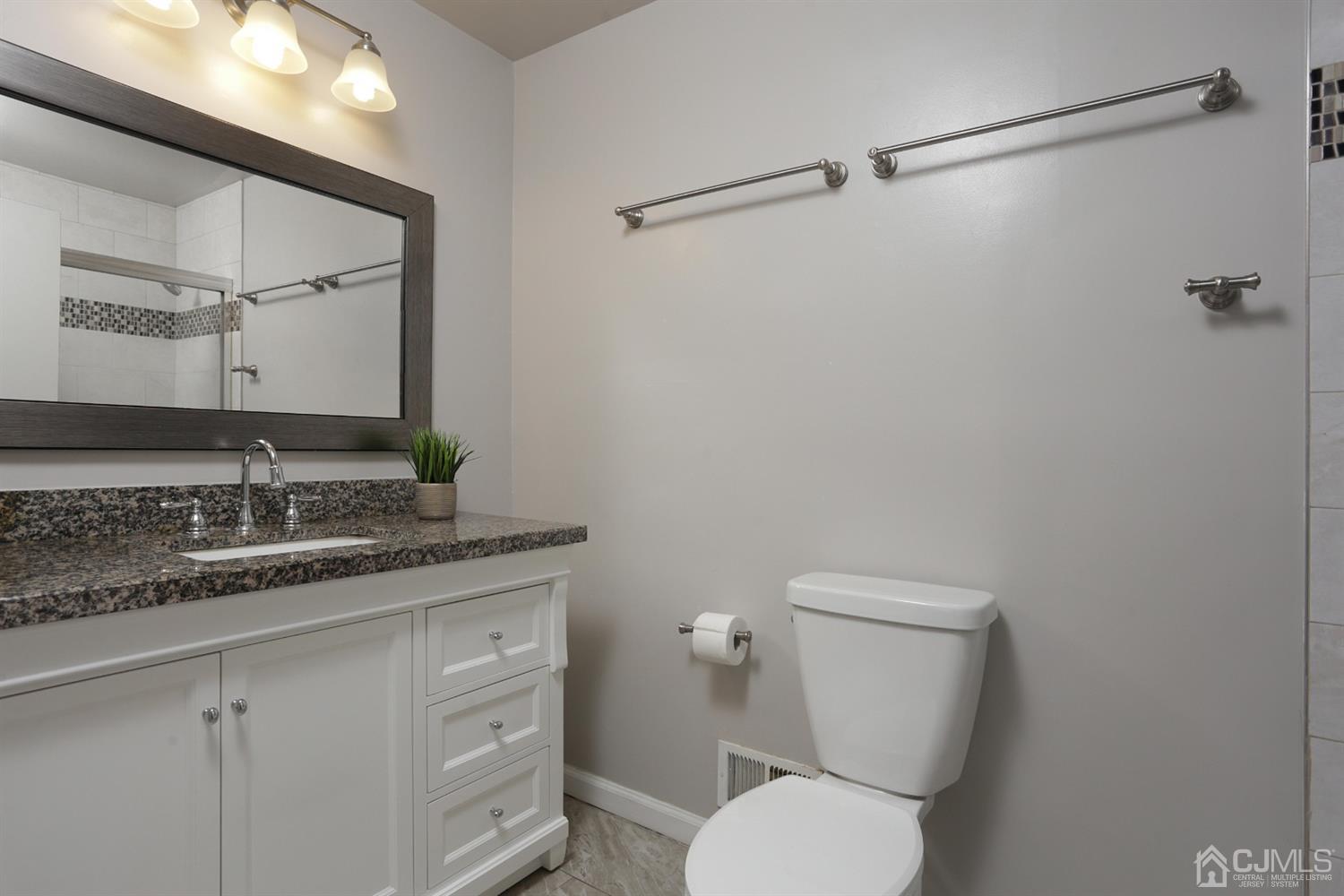 40 Azalea Drive Edison, NJ 08820 - Photo 27 of 36 a bathroom with a granite countertop toilet sink and mirror