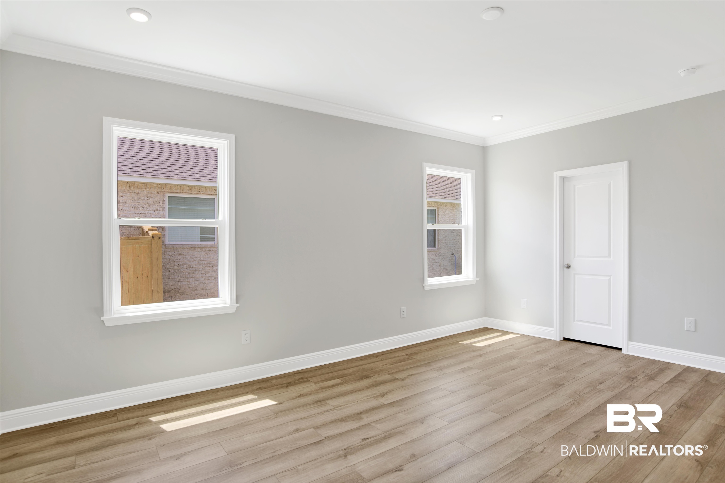 23852 Lafite Circle Daphne, AL 36526 - Photo 17 of 30 Spare room featuring light wood-style flooring and ornamental molding