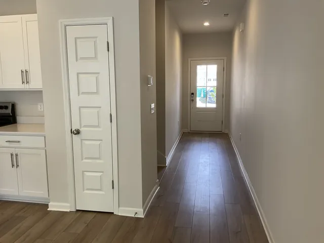 a view of hallway with wooden floor
