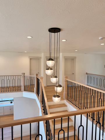 3626 Riverstone Road Mapleton, UT 84664 - Photo 30 of 58 Hallway featuring light wood-type flooring, a textured ceiling, an upstairs landing, and recessed lighting
