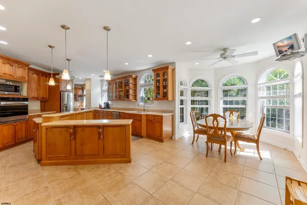 a kitchen with stainless steel appliances granite countertop a sink counter space cabinets and a stove