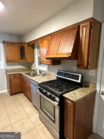 a kitchen with a stove a sink and a microwave