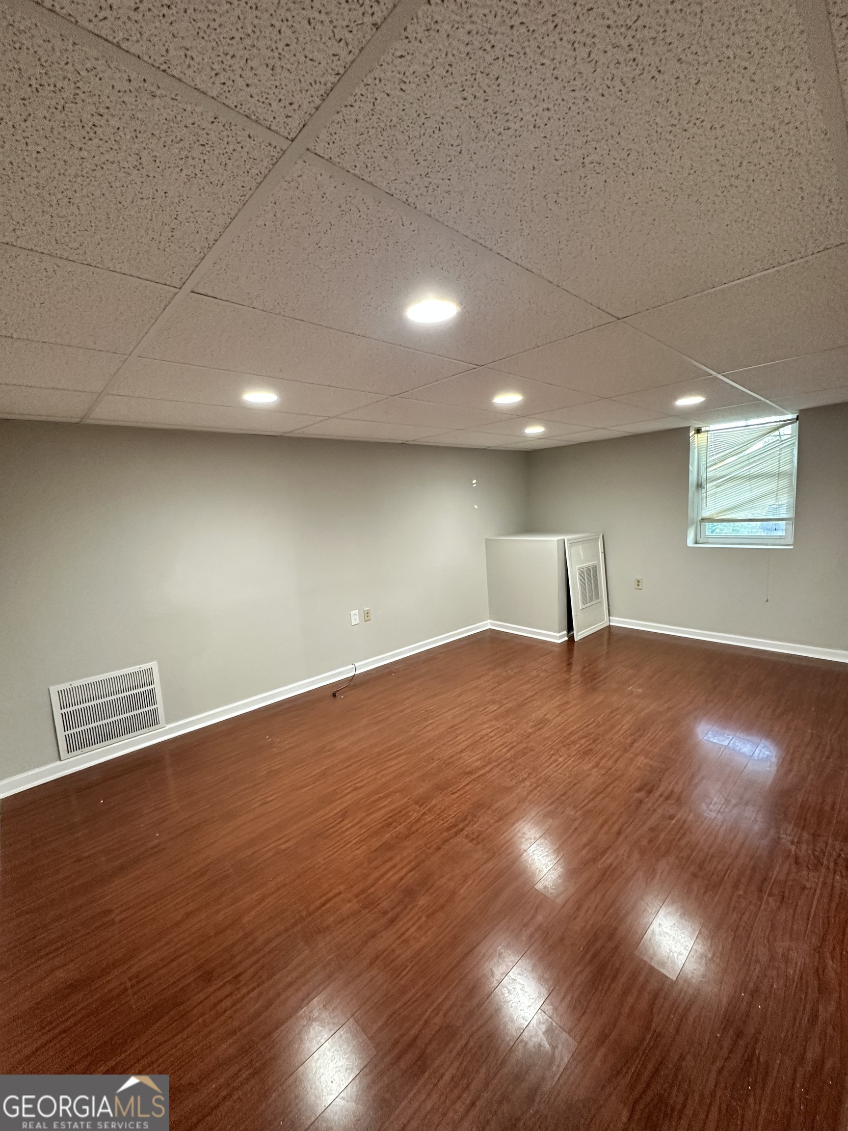 1865 Vicki Lane Southeast Atlanta, GA 30316 - Photo 5 of 15 an empty room with wooden floor and windows
