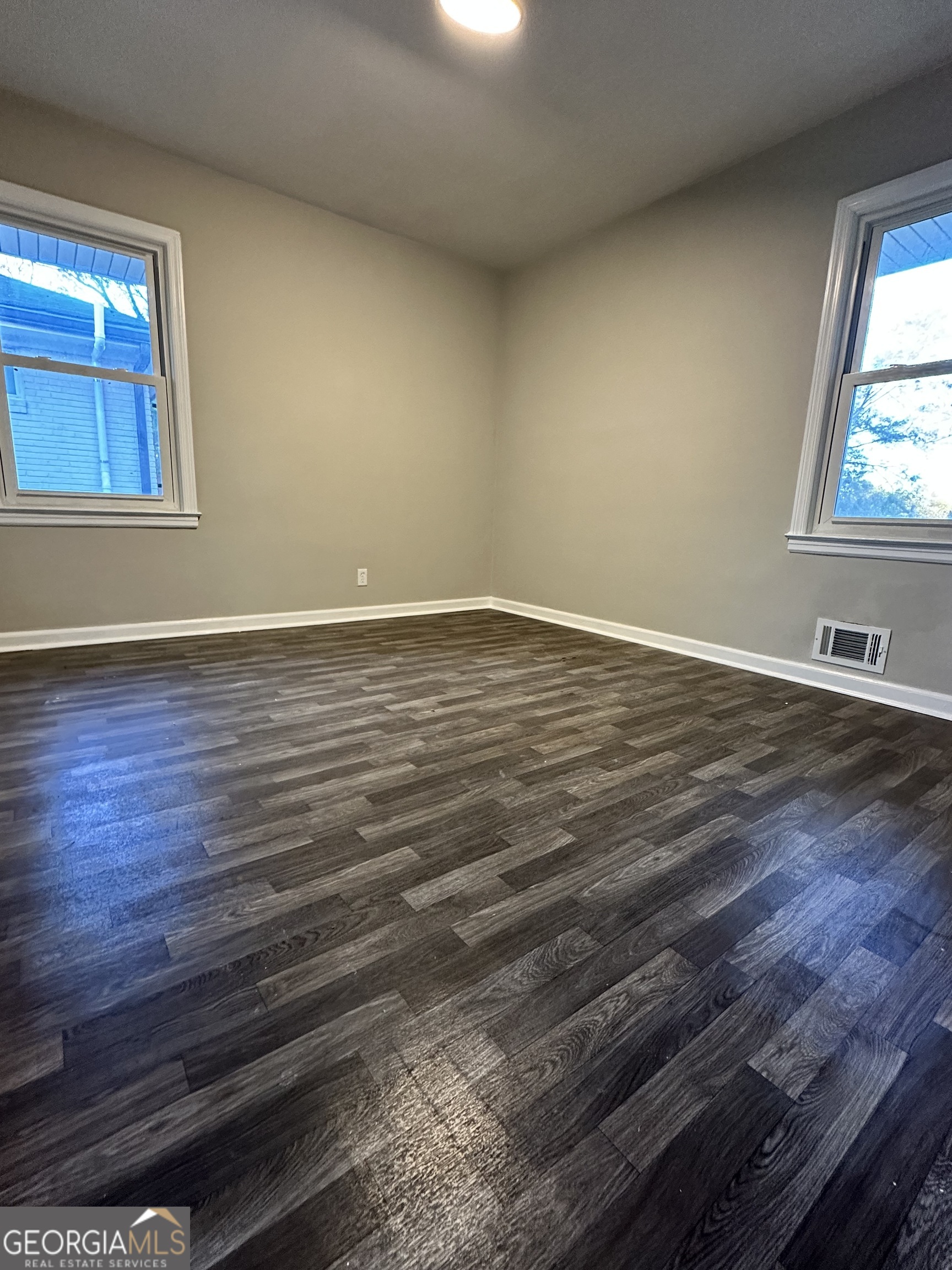 1865 Vicki Lane Southeast Atlanta, GA 30316 - Photo 10 of 15 a view of an empty room with wooden floor and a window
