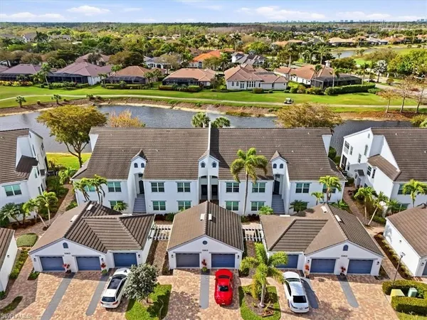 an aerial view of residential houses with outdoor space and swimming pool