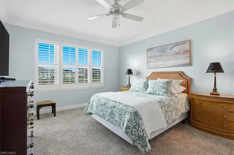 a bedroom with a bed and a desk