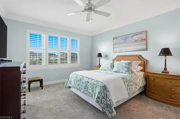 a bedroom with a bed and a desk