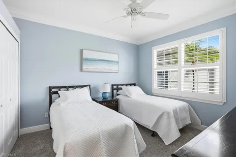 a bedroom with two beds and a window