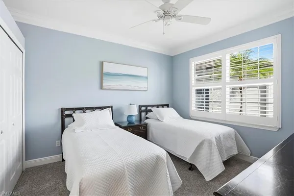 a bedroom with two beds and a window