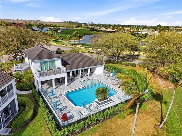 an aerial view of house with yard swimming pool and ocean view