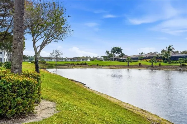 a large room with lots of furniture and a large mirror