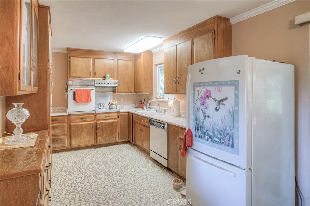 1361 Mt Ida Road Oroville, CA 95966 - Photo 4 of 44 a kitchen with a sink a stove a refrigerator and cabinets