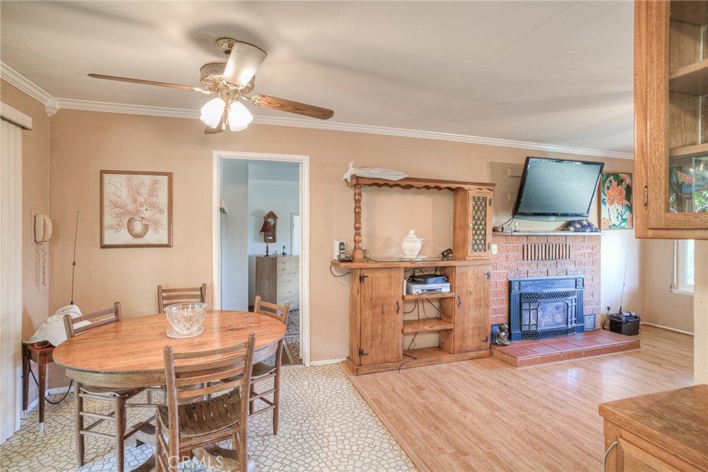 1361 Mt Ida Road Oroville, CA 95966 - Photo 7 of 44 a view of a livingroom with furniture wooden floor a flat screen tv and a fireplace
