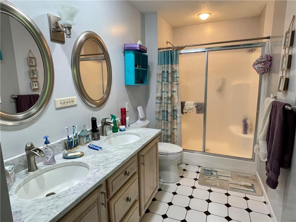 123 Hunt Road Butler, PA 16001 - Photo 22 of 44 a bathroom with a sink a toilet and a mirror