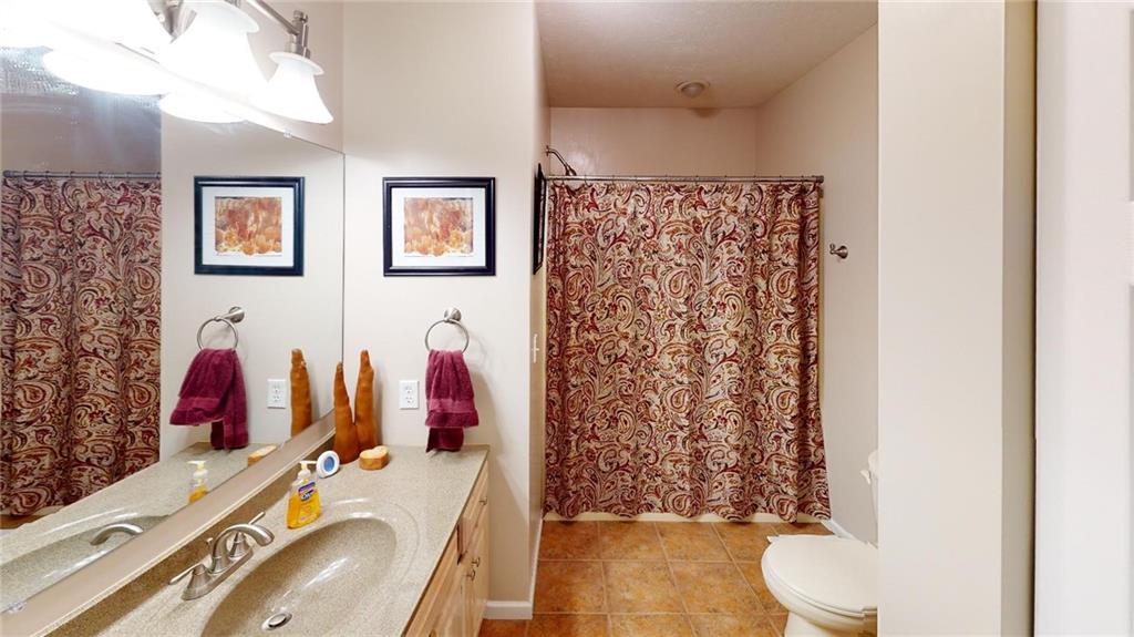 123 Hunt Road Butler, PA 16001 - Photo 26 of 44 a bathroom with a sink toilet and shower curtain