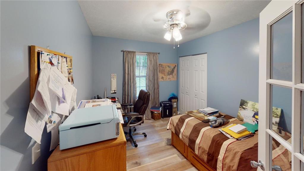 123 Hunt Road Butler, PA 16001 - Photo 27 of 44 a bed room with a bed and a chandelier